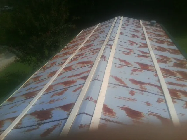 Rusted metal roof panels with new wood purlins before replacement — Storm Damage Roof Repair in Aguanga by Roofing Brothers