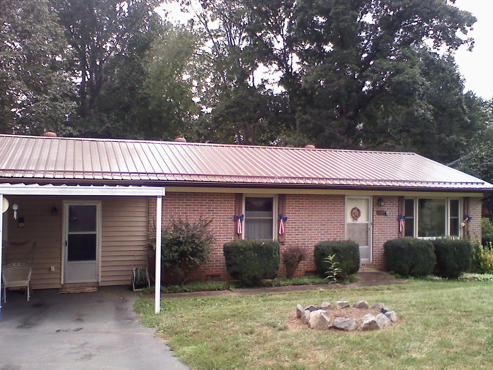 Bronze metal roof and carport on a brick ranch home — Roof Repair work by our crew in Aguanga