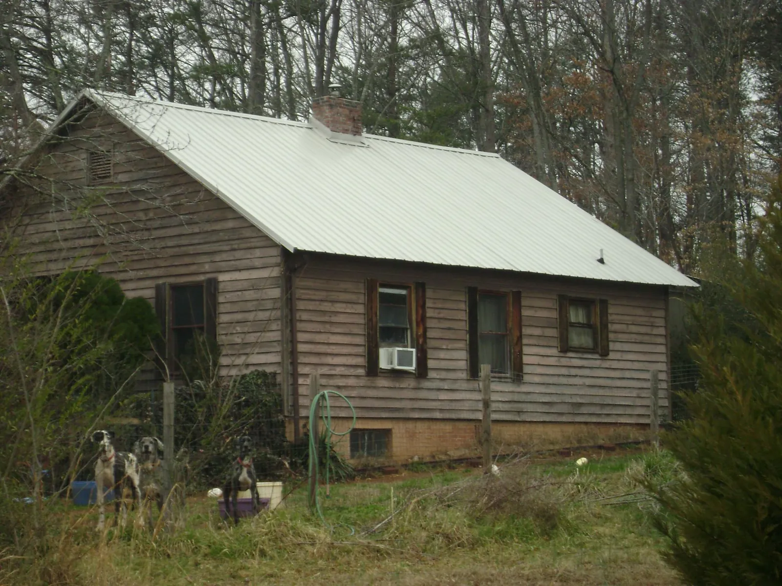 White metal roof on an old wood sided farmhouse, from a Metal Roof Installation job in Aguanga